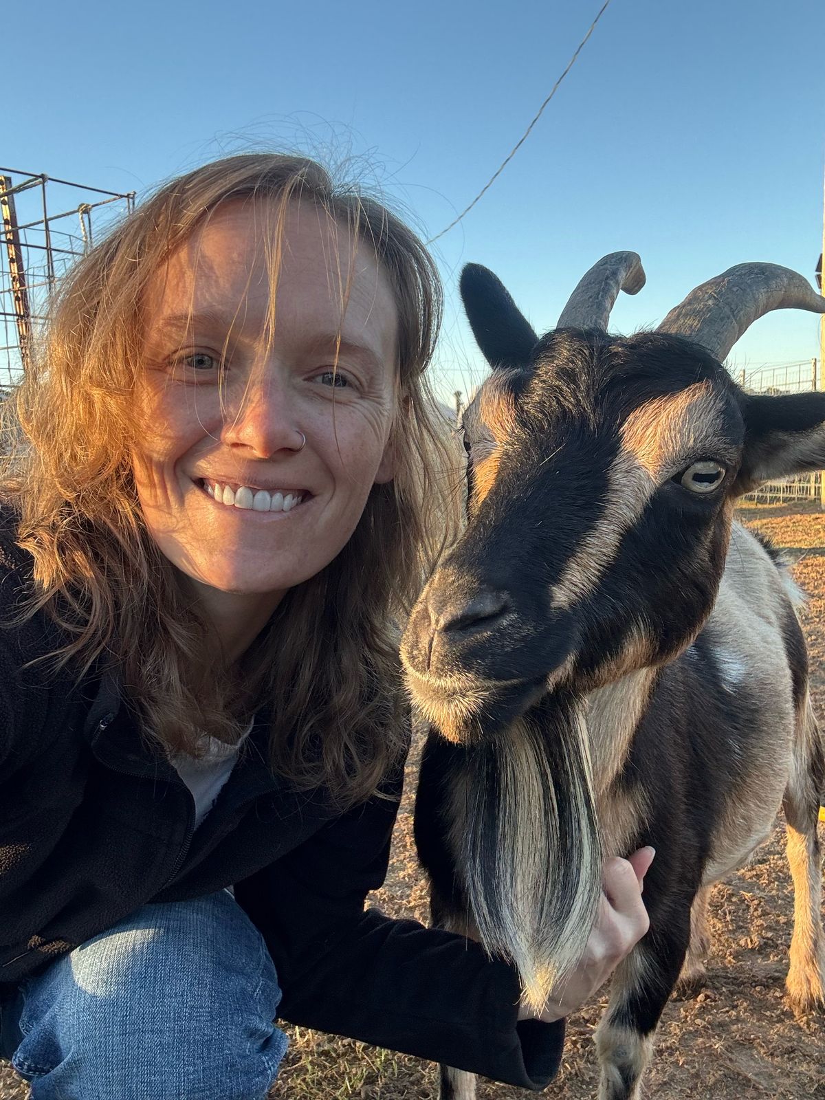 DeNora smiling with one of our goats